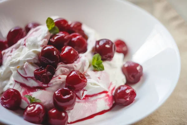 Cottage cheese cream and cream dessert with cherries and mint fo — Stock Photo, Image