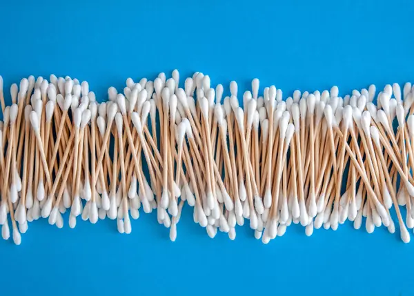 Composición de hisopos de algodón de madera sobre un fondo azul-cian-lila —  Fotos de Stock