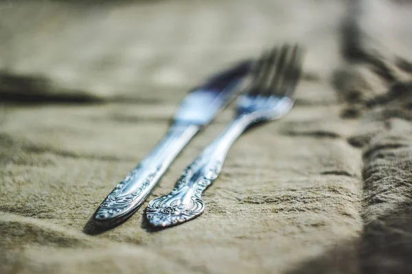 retro vintage cutlery knife and fork on antique tablecloth