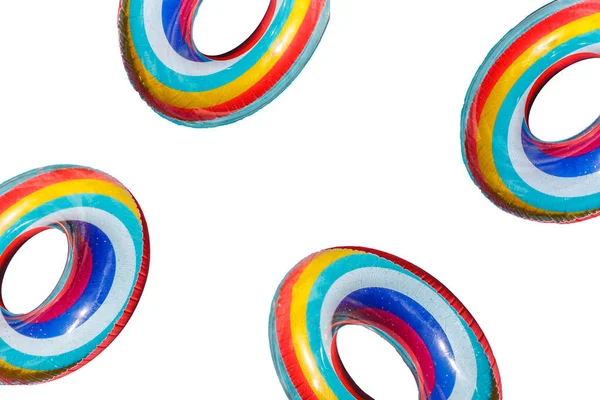 Quatre bouées de sauvetage multicolores en caoutchouc gonflable isolées sur un fond blanc — Photo