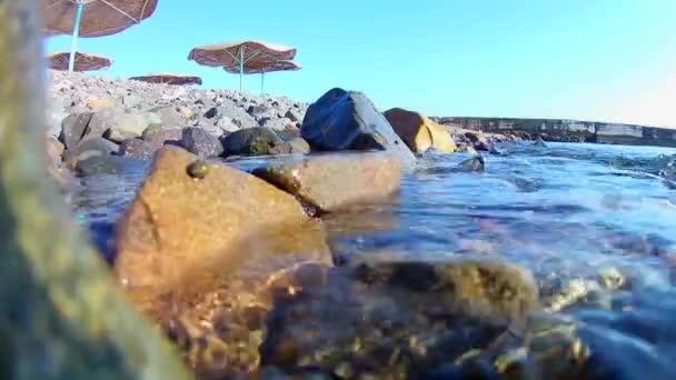 Sea Waves Roll Coastal Rocky Shore Beach Thatched Umbrellas You — Stock Video