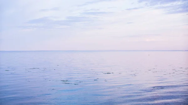 The sky touches the earth during the sunset at the bay