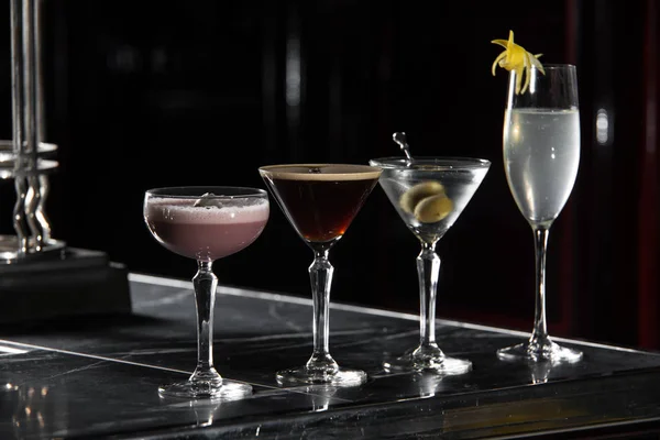 Fyra särskilda drinkar på en bar skrivbord. svart bakgrund — Stockfoto