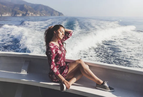 Happy young amazing woman wearing relaxing on the yacht in Cinque Terre, Italy, Ligurian Sea, outdoor