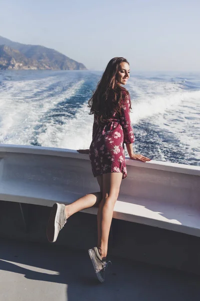 Happy young amazing woman wearing relaxing on the yacht in Cinque Terre, Italy, Ligurian Sea, outdoor