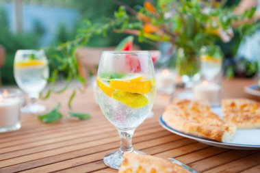 Aile açık yemek bahçede yaz gün batımında. Piknik yiyecek ve içecek konsepti