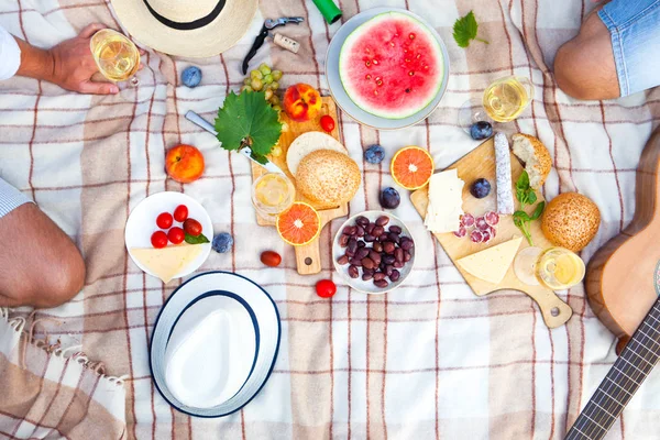 Summer Picnic Basket on the Green Grass in italian garden. Food and drink concept. Friends Party time