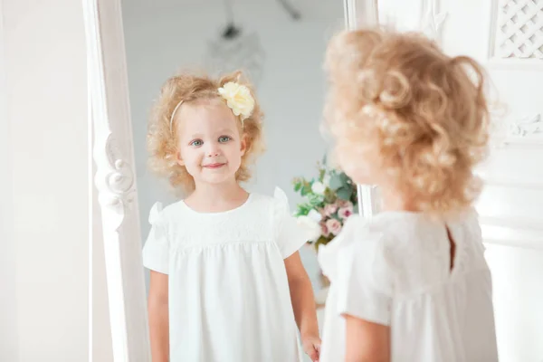 Duas lindas meninas olham no espelho