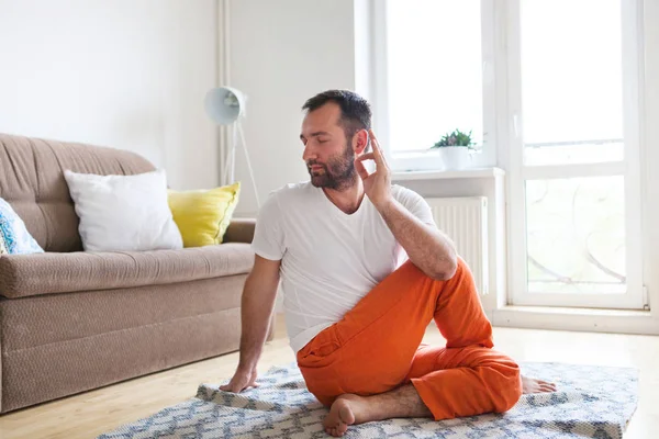 Man practicing yoga and meditation at home. A series of yoga pos