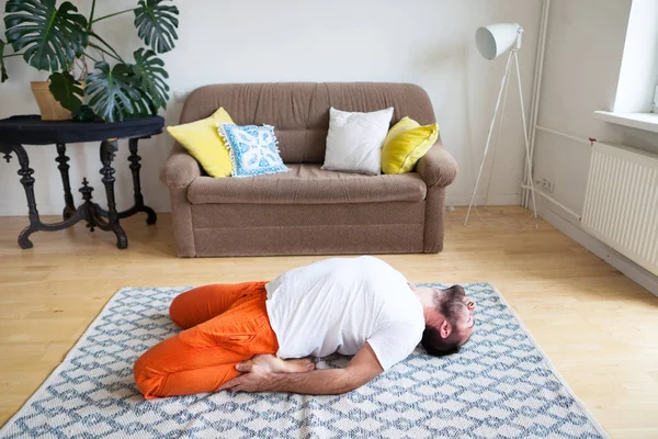 Man practicing yoga and meditation at home. A series of yoga pos