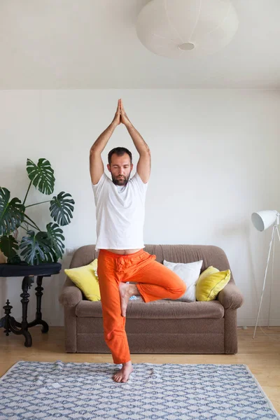 Man practicing yoga and meditation at home. A series of yoga pos