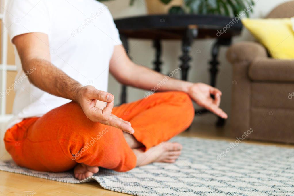 Close Up. Man practicing yoga and meditation at home. A series o