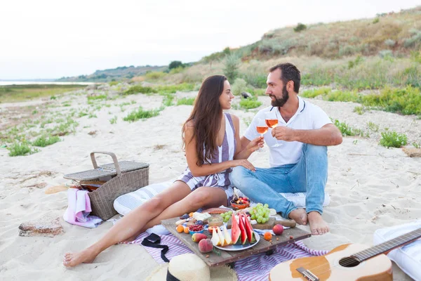 Picknick på stranden vid solnedgången i stil med Boho, mat och dri — Stockfoto