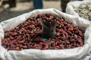 Rose hips bir pazar satışı için bir çuval içinde kurumuş. Köpek gül yakın çekim yukarı.