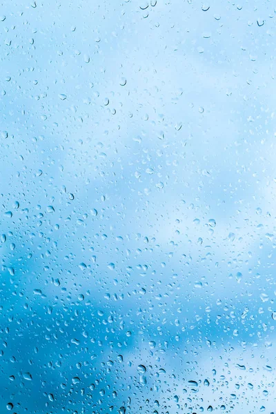 Drops of rain on blue glass background — Stock Photo, Image