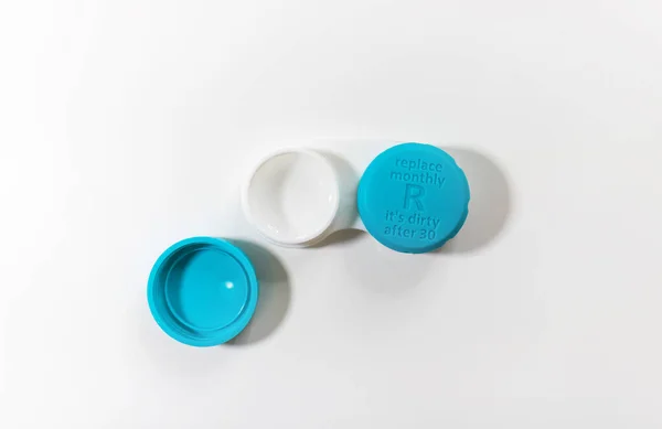 Illustrate a blue color contact lens case with lid written replace monthly it is dirty after 30 on a white background