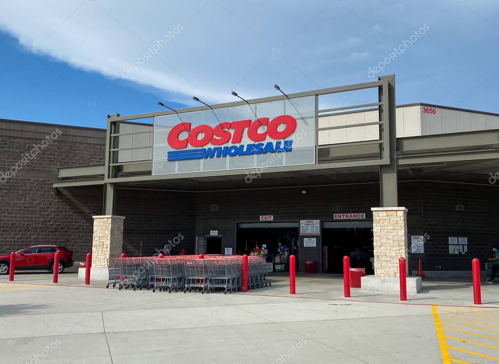 Mckinney, TX / USA - August 12, 2020: Costco Wholesale Entrance with shopping carts and customers in a sunny day