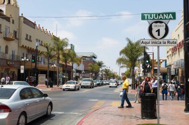 TIJUANA, BAJA CALIFORNIA/MEXICO - JUNE 20, 2018:  People walk along Avenida Revolucion, the city's main thoroughfare and a popular destination for Americans traveling south of the San Diego border. clipart