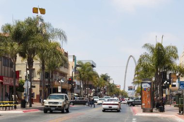 TIJUANA, BAJA CALIFORNIA/MEXICO - JUNE 20, 2018:  Traffic along Avenida Revolucion, the main thoroughfare of the city, with a view of the landmark Monumental/Millennial Arch (Arco y Reloj Monumental). clipart