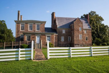 SURRY, VIRGINIA/USA - JULY 20, 2019: The rear view of Bacon's Castle,  the oldest documented brick dwelling in the United States, clipart