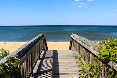 Walkway leading to Ocean View Beach in Norfolk, Virginia with the Chesapeake Bay in the background. clipart