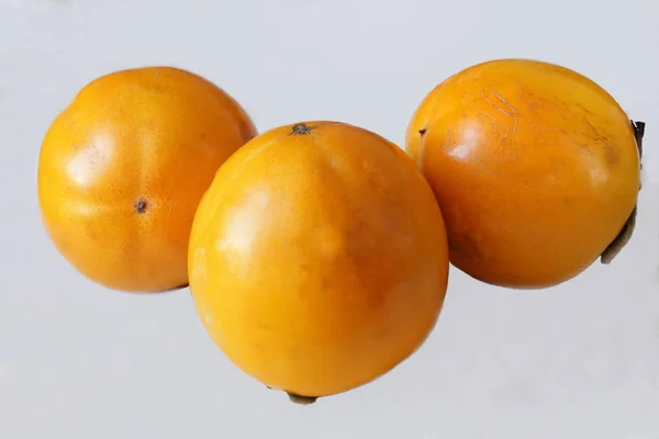 Ripe persimmon on a white background grown in the garden — Stock Photo, Image