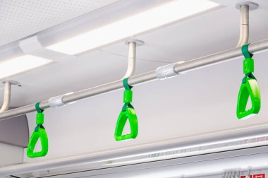 Modern bir tren ayakta yolcu handholds asılı. Banliyö ve kentsel ulaşım