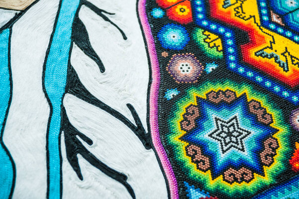 MOSCOW, RUSSIA - June 29, 2018: The 2018 FIFA World Cup. A National house for Mexican fans in Gostiny Dvor. National Souvenirs crafts of the Huichol mosaic of beads. A fragment of inlaid soccer ball