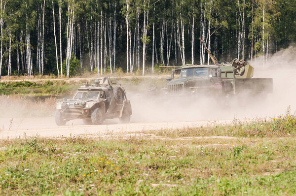 ALABINO MILITARY TRAINING GROUND, MOSCOW OBLAST, RUSSIA - August 26, 2018:  International forum ARMY-2018. The military dune buggy "Eskadron" and antiaircraft site ZU-23M on Ural-4320 chassis