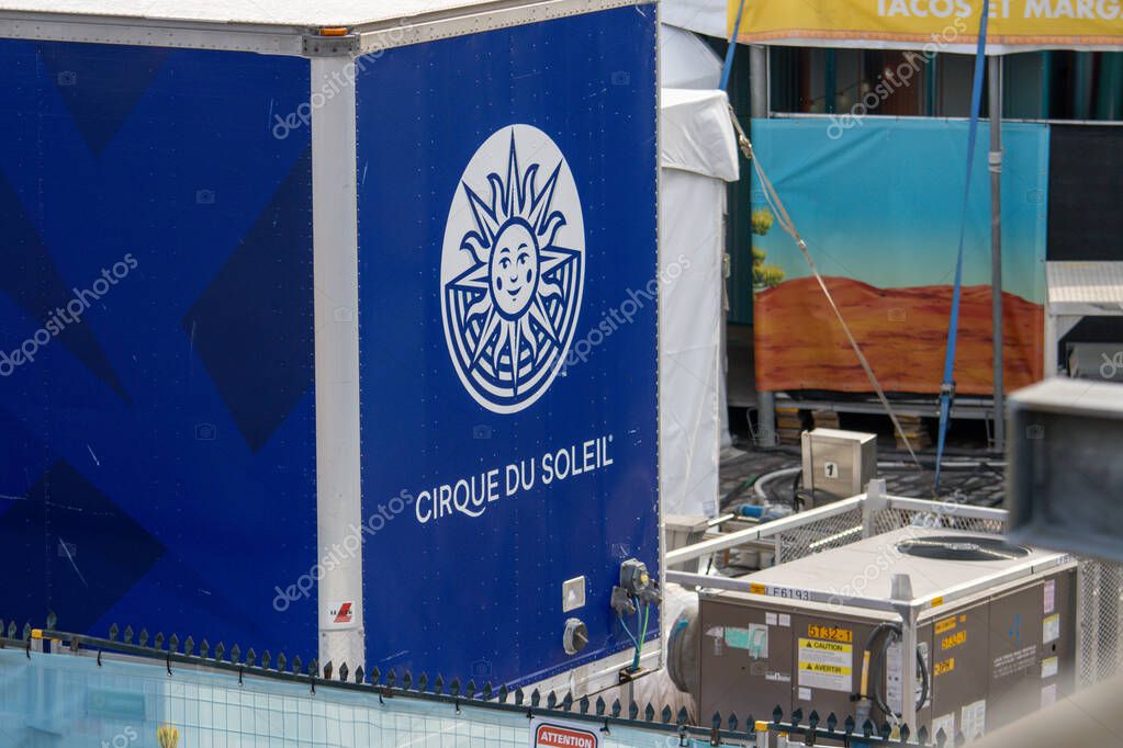 Quebec, Canada, 05 July 2025 : Cirque du Soleil trailer with sun logo and festival installation nearby