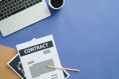 Ofis Masası adlı kullanıcının alanı - düz çalışma üstten görünüm fotoğraf bir çalışma alanı, dizüstü bilgisayar, sözleşme sayfası, kahve fincanı ve defter koyu mavi zemin üzerine yatırın. Derin mavi renk kopyalama alanı çalışma Resepsiyon kavramı.