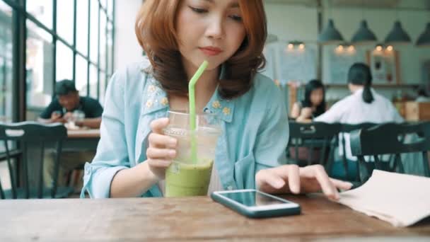 Fröhliche Fröhliche Junge Asiatische Frau Sitzt Café Und Trinkt Grünen — Stockvideo
