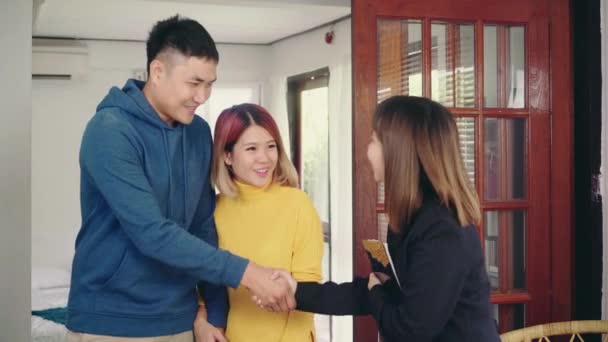Happy Young Asian Couple Realtor Agent Cheerful Young Man Signing — Stock Video