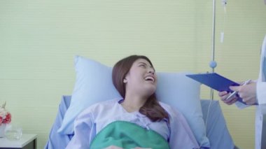 Güzel akıllı Asyalı doktor ve tartışmak ve Pano Doktor elinde bir şeyler olurken, hastanın yatakta Hastanesi'nde açıklayan hasta. Tıp ve sağlık kavramı.