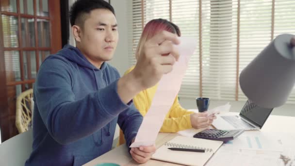 Young Stressed Asian Couple Managing Finances Reviewing Bank Accounts Using — Stock Video