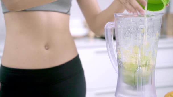 Slow Motion Sporty Asian Woman Using Blender Make Apple Juice — Stock Video