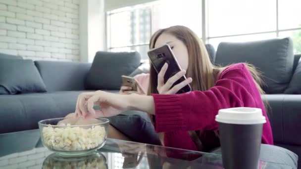 Asian Women Using Smartphone Eating Popcorn Living Room Home Group — Stock Video