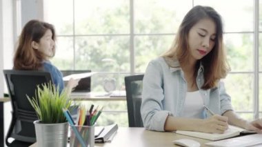 Asya iş ofis, birlikte işyerinde çalışan kadın akıllı rahat kıyafet masasında otururken bilgisayarda çalışan kadınlar. Yaşam tarzı kadın iş yerinde office kavramı.