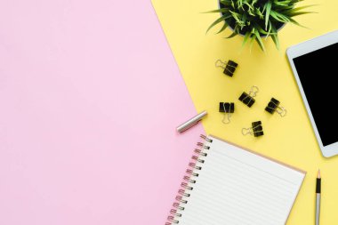 Ofis Masası adlı kullanıcının alanı - düz çalışma üstten görünüm fotoğraf çalışma alanı boş sahte tablet, ağaç bitki ve defter pastel zemin üzerine yatırın. Pastel pembe sarı renkli kopya alanı çalışma Resepsiyon kavramı.