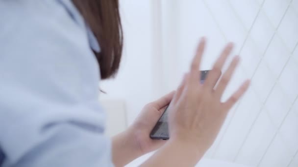 Junge Asiatische Frau Mit Smartphone Während Auf Dem Bett Liegend — Stockvideo