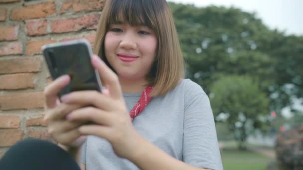 Traveler Asian Woman Using Smartphone Checking Social Media While Relax — Stock Video