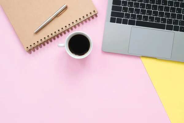 Creative flat lay photo of workspace desk. Top view office desk with laptop, blank empty notebooks and coffee cup on pastel color background. Top view with copy space, flat lay photography.