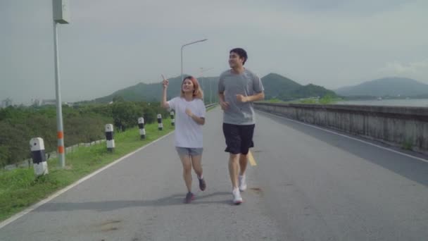 Slow Motion Asian Runner Couple Running Jogging Street Healthy Young — Stock Video