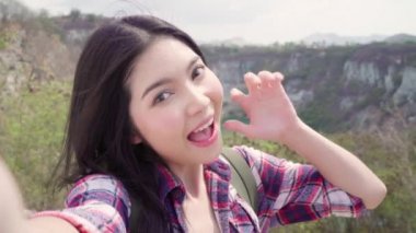 Asya sırt çantalı kadın selfie dağın tepesinde, genç kadın mutlu cep telefonu kullanarak selfie alarak yürüyüş macera tatil keyfini çıkarın. Yaşam tarzı kadın seyahat ve dinlenme kavramı.