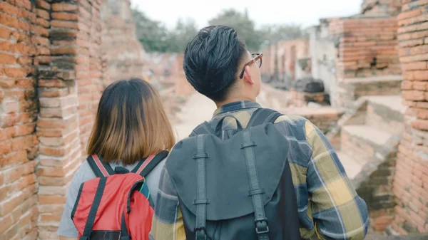 Traveler Asian couple spending holiday trip at Ayutthaya, Thailand, backpacker sweet couple enjoy their journey at amazing landmark in traditional city. Lifestyle couple travel holidays concept.