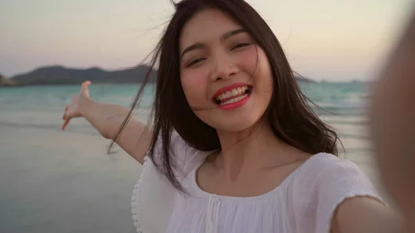 Blogger Asian Woman rekord Vlog wideo na plaży, Młoda piękna kobieta szczęśliwy za pomocą telefonu komórkowego zrobić Vlog wideo na plaży w pobliżu morza, gdy zachód słońca wieczorem. Lifestyle kobiet podróży na plaży koncepcji. — Zdjęcie stockowe