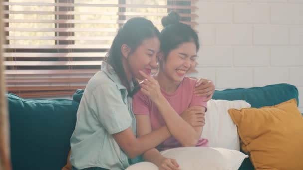 若いレズビアンLgbtqアジアの女性カップルは自宅で抱擁し 魅力的なアジアの恋人プライド女性ハッピーリラックスは リビングルームのコンセプトでソファを横たえながら一緒にロマンチックな時間を過ごします スローモーション — ストック動画