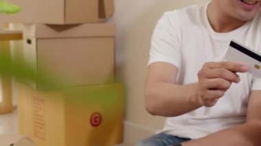 Mutlu Asya 'lı genç çift yeni bir ev aldı. Telefon, kredi kartı, e-ticaret interneti kullanan Koreli bir aile büyük modern bir evde yerde oturuyor. Yeni gayrimenkul konut, kredi ve ipotek.