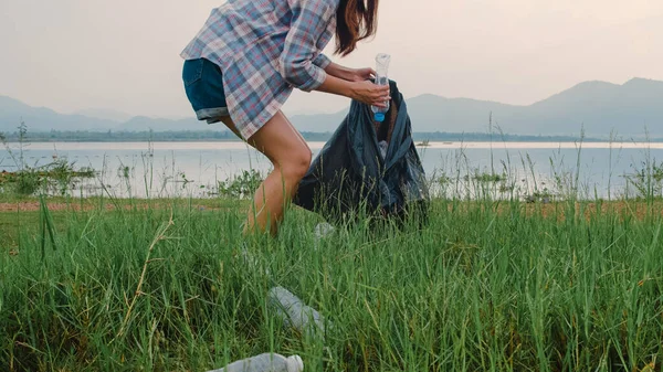 快乐的年轻的亚洲积极分子在海滩上收集塑料垃圾 韩国女性志愿者帮助保持自然清洁和捡垃圾 环境保护及污染问题的概念 — 图库照片