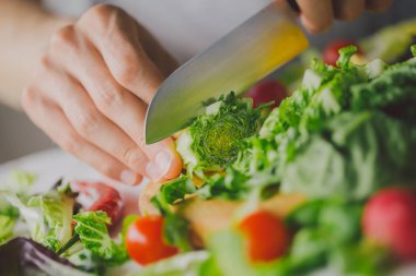 Taze yemek hazırlama adam masada sağlıklı salata detoks. Sarı kırmızı biber kesme. Portre